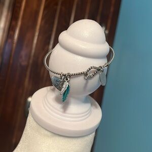 Thirty one JK bracelet with 2 charms.  Heart and feathers.